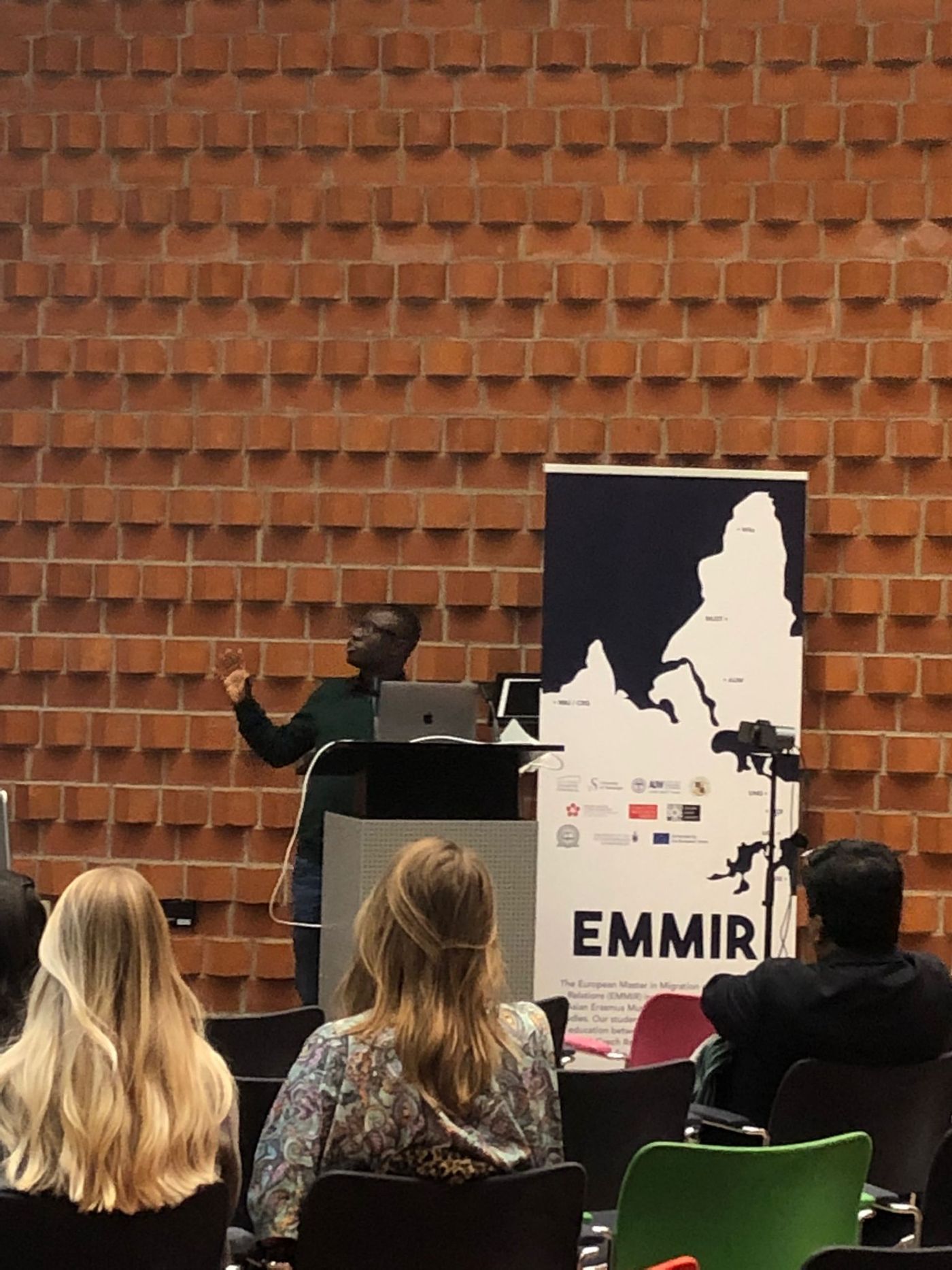 Dr. Rueben Okine presenting at a university lecture hall